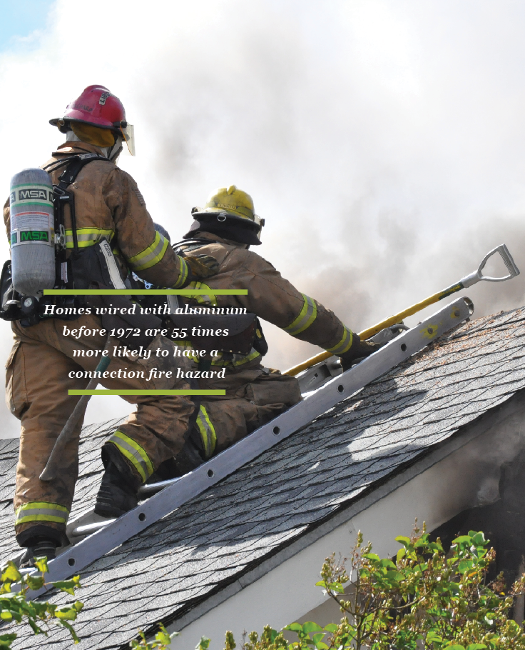 firefighters on roof of a house on fire