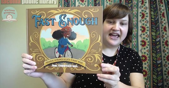Librarian holds up book Librarian holds up book