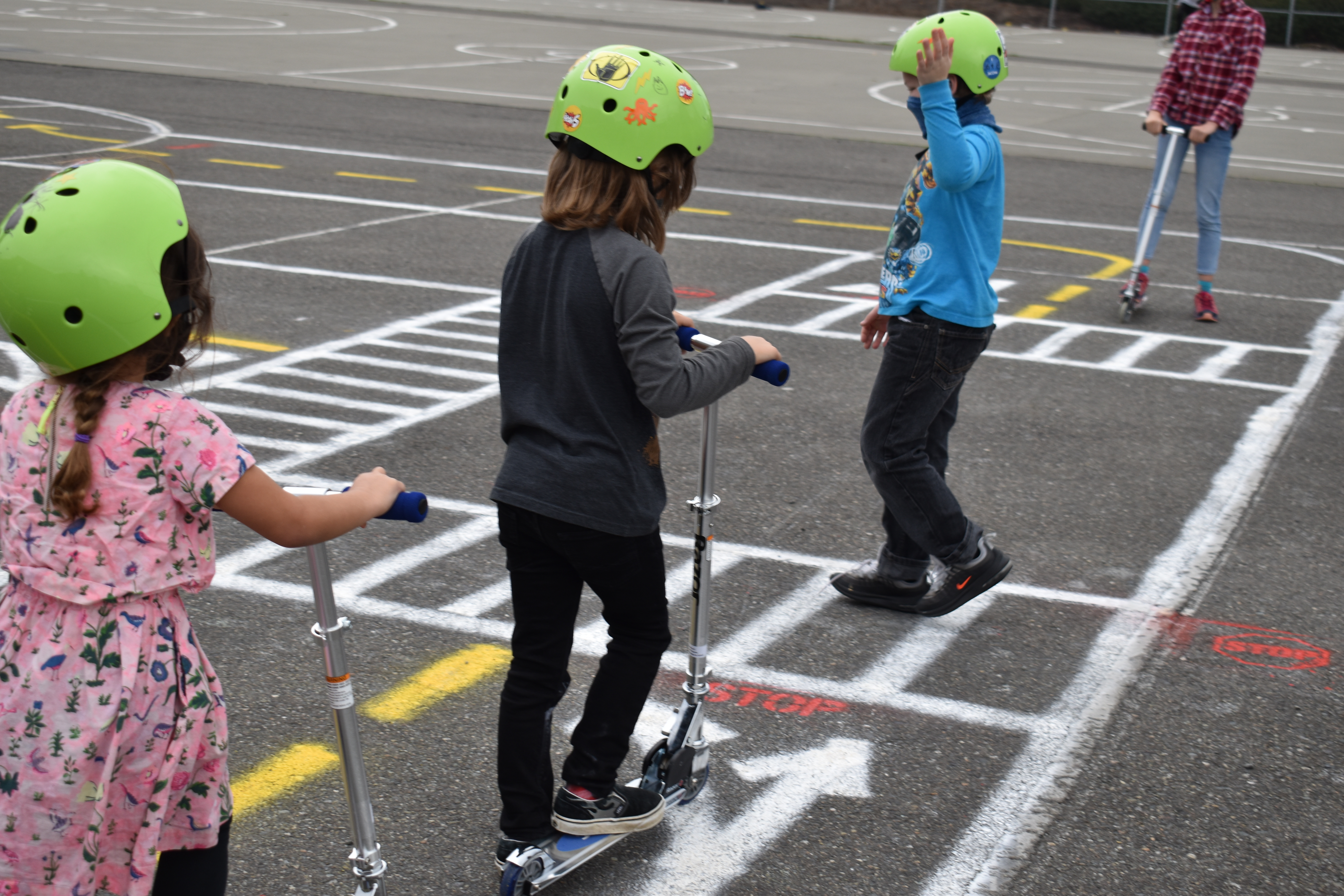 kids practicing walking safety across a mini scale street