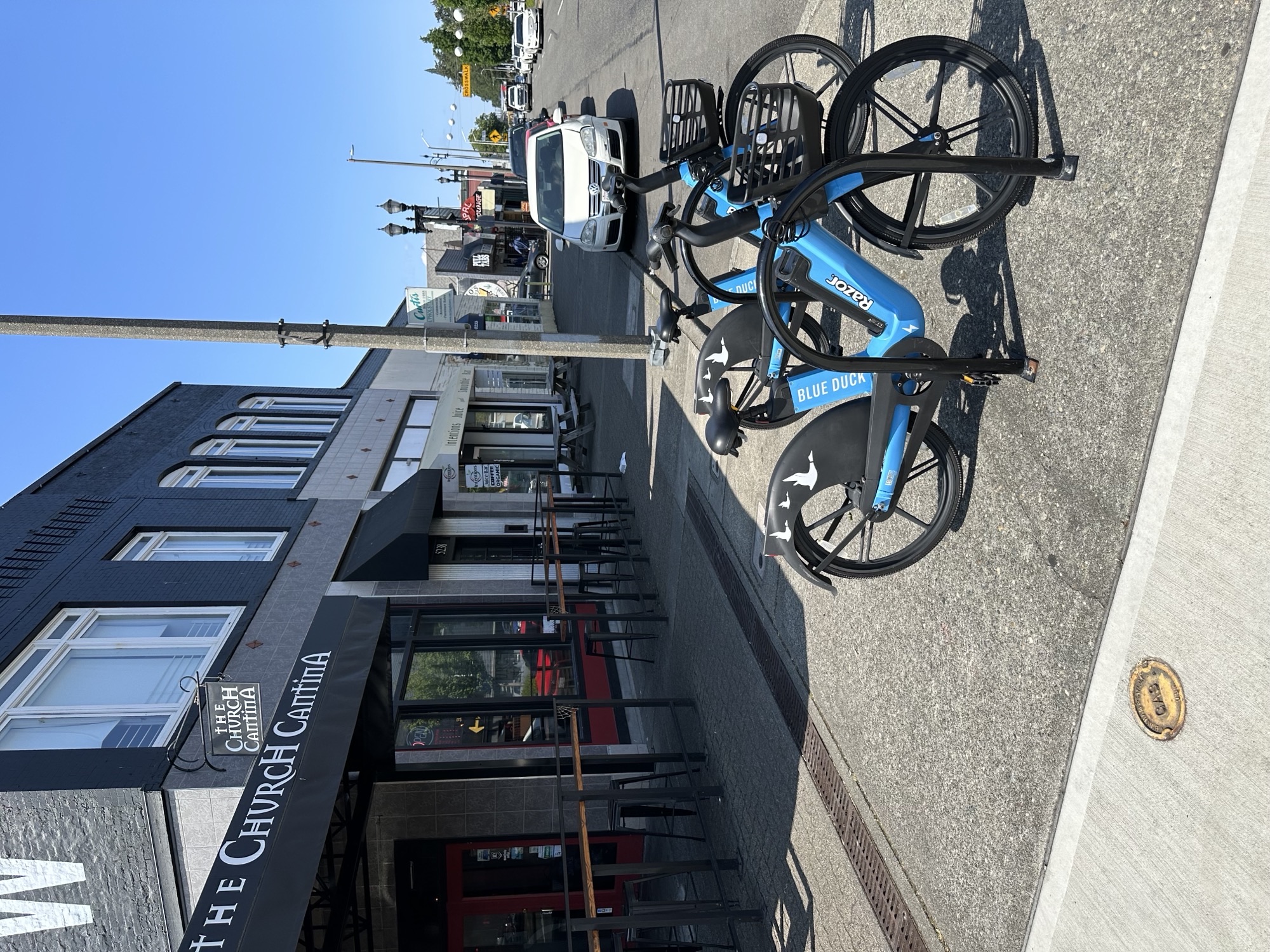 Bright blue e-bikes parked in the South Tacoma Business District